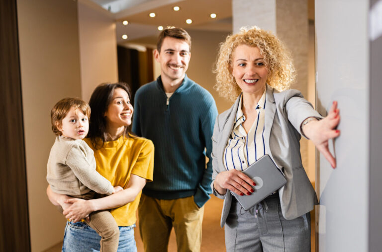 estate agent showing a family around a modern home interior during property viewing