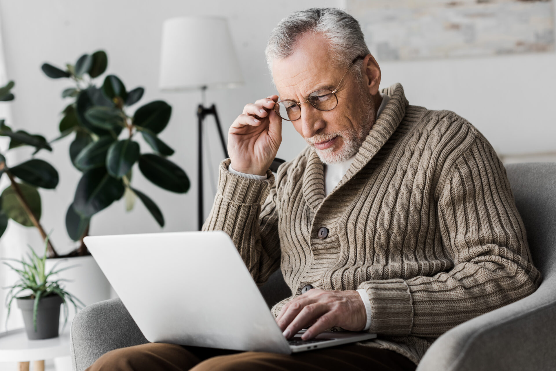 landlord reviewing new rental laws and tenancy documents on laptop at home