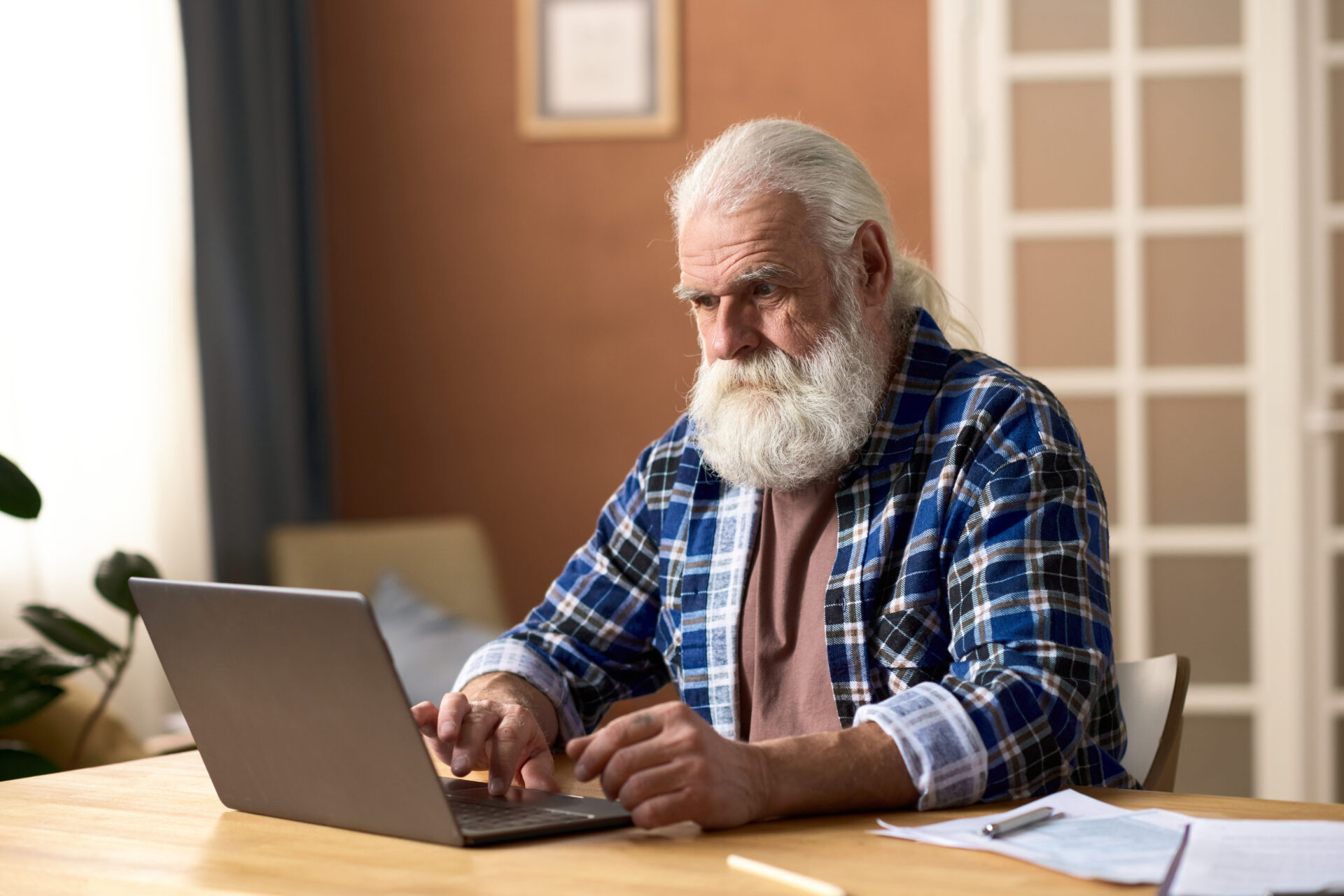 landlord reviewing rental property figures on laptop at home office desk