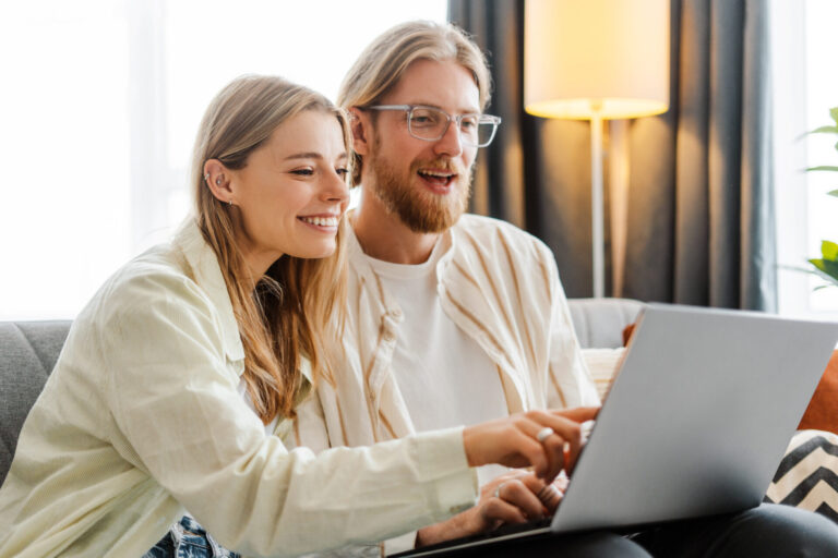 couple reviewing rental property options on laptop at home in Annan