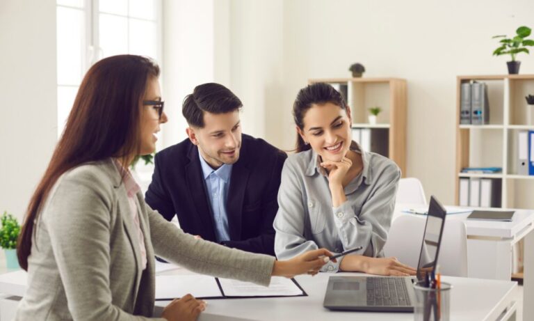Landlords discussing rental property performance and buy-to-let opportunities with a letting agent in Bridgend.