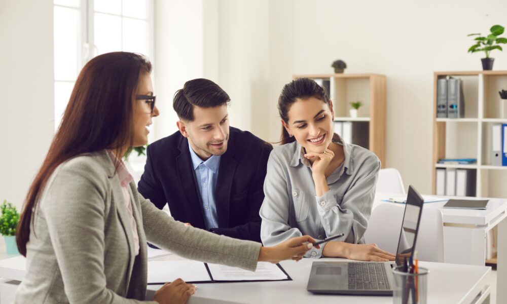 Landlords discussing rental property performance and buy-to-let opportunities with a letting agent in Bridgend.