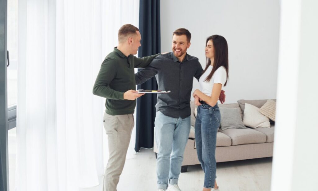 Estate agent showing a modern home to a young couple in Consett property market