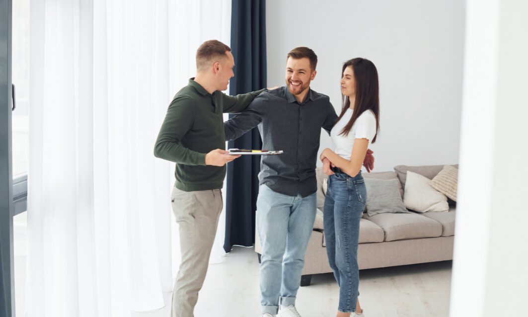 Estate agent showing a modern home to a young couple in Consett property market