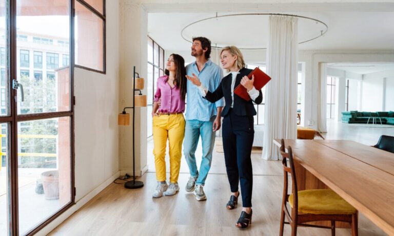 Estate agent showing a modern property to a couple in Gravesend