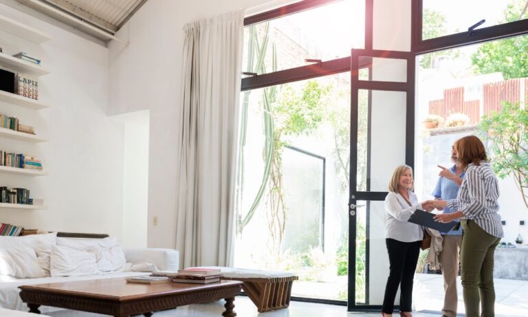 Landlord greeting prospective tenants during a property viewing in a bright modern home in Harrogate.