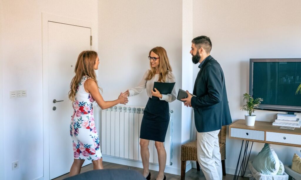 Estate agents welcoming a buyer inside a modern new-build home in Kendal