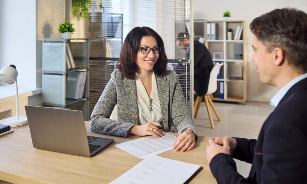 Landlord meeting with a tenant in a modern office to discuss rental property investment and returns in Stanmore.