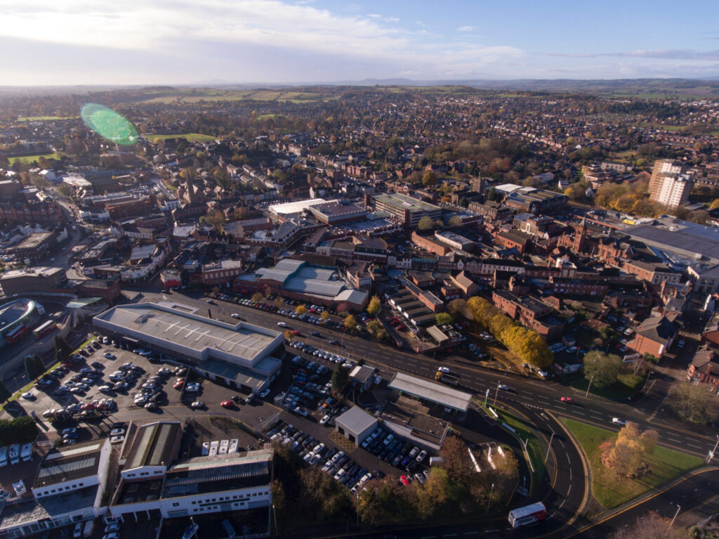 Drone view overlooking Stourbridge town centre, residential neighbourhoods and surrounding countryside in the West Midlands.