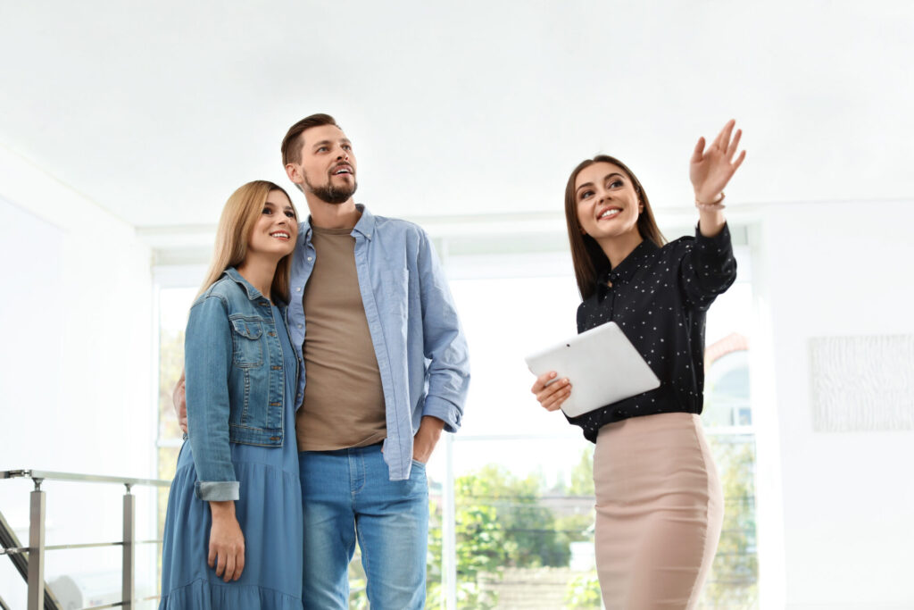 Estate agent showing a property to a couple in Ancoats M4 Manchester