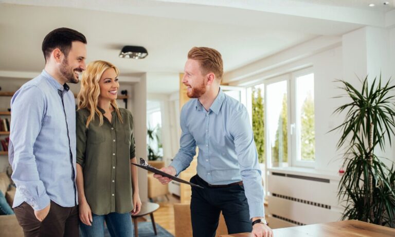 Estate agent showing a property to prospective buyers in Bushey Heath WD23