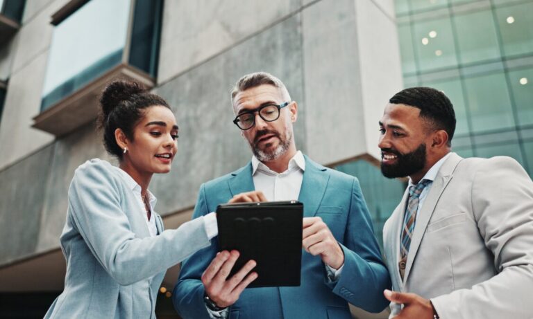 Property professionals reviewing documents outside an office, representing Hunters Bishopsworth landlord legislation support, compliance advice and rental management.