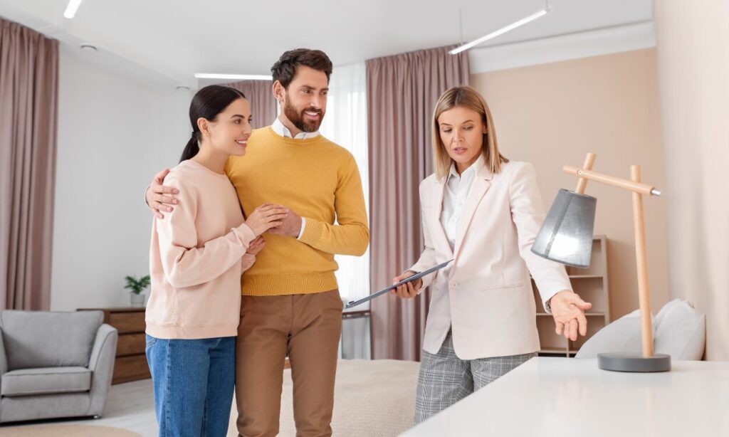 A property agent showing a couple around a bright home, representing buyers and renters exploring homes and lifestyle options in Shirley B90.