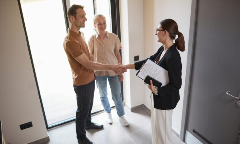 Letting agent greeting tenants inside a rental property, representing Harrogate rental yields, landlord advice and buy-to-let property management.