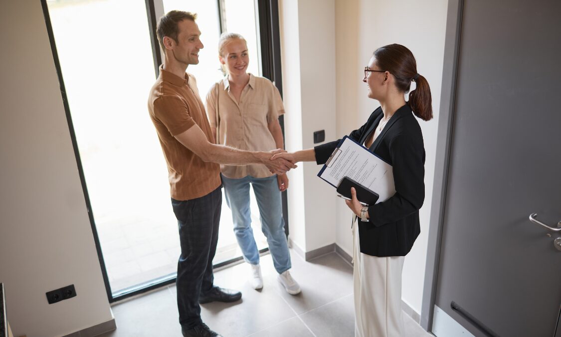 Letting agent greeting tenants inside a rental property, representing Harrogate rental yields, landlord advice and buy-to-let property management.