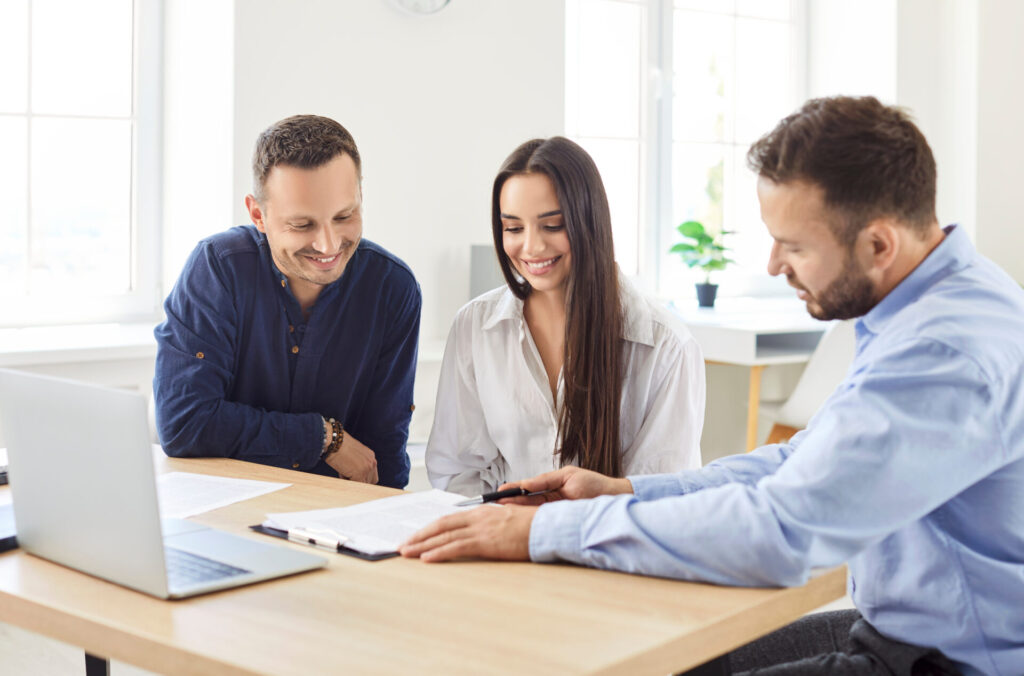 Landlord and tenants reviewing tenancy documents and property licensing requirements in Manchester rental market