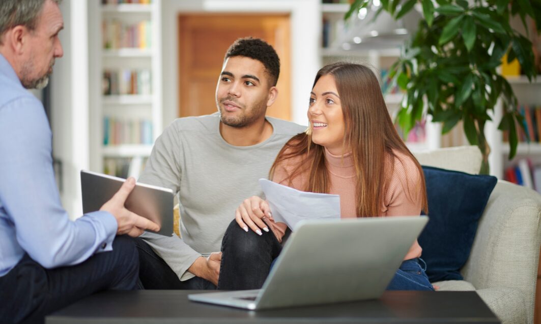 Estate agent discussing property options with a couple in Shenstone WS14