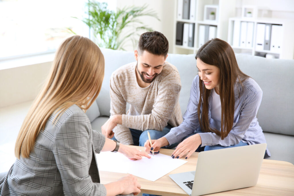 Letting agent advising a couple on rental paperwork, representing Stourbridge rental yields and buy-to-let investment guidance.