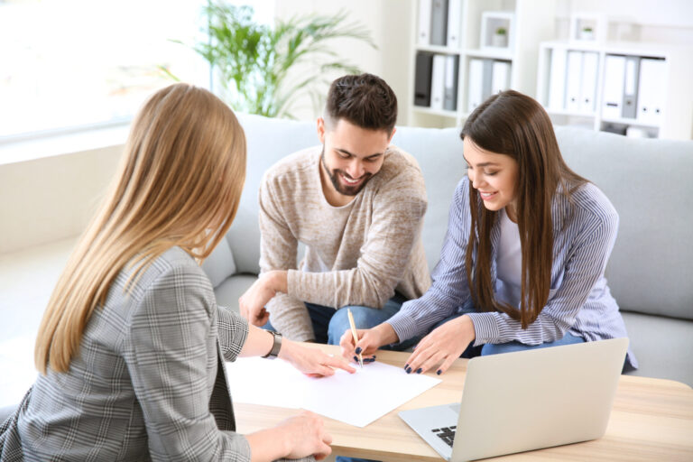 Letting agent advising a couple on rental paperwork, representing Stourbridge rental yields and buy-to-let investment guidance.