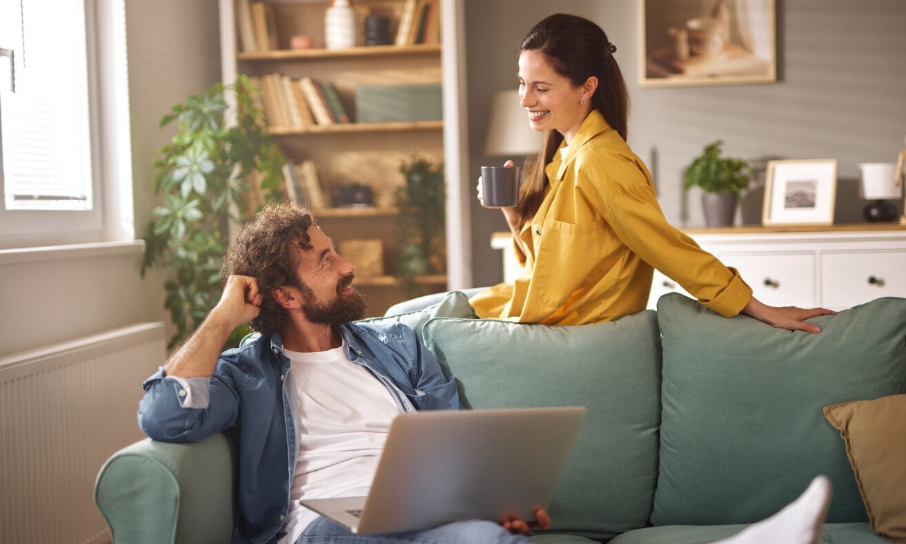 Couple relaxing inside a modern home, representing the Streethay WS13 area guide, local lifestyle, buying and renting advice.