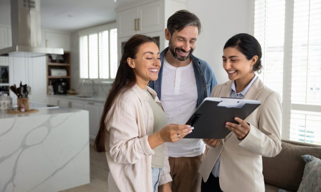 Letting agent reviewing property details with tenants inside a modern rental home, representing Tamworth rental yields, landlord advice and buy-to-let property management.