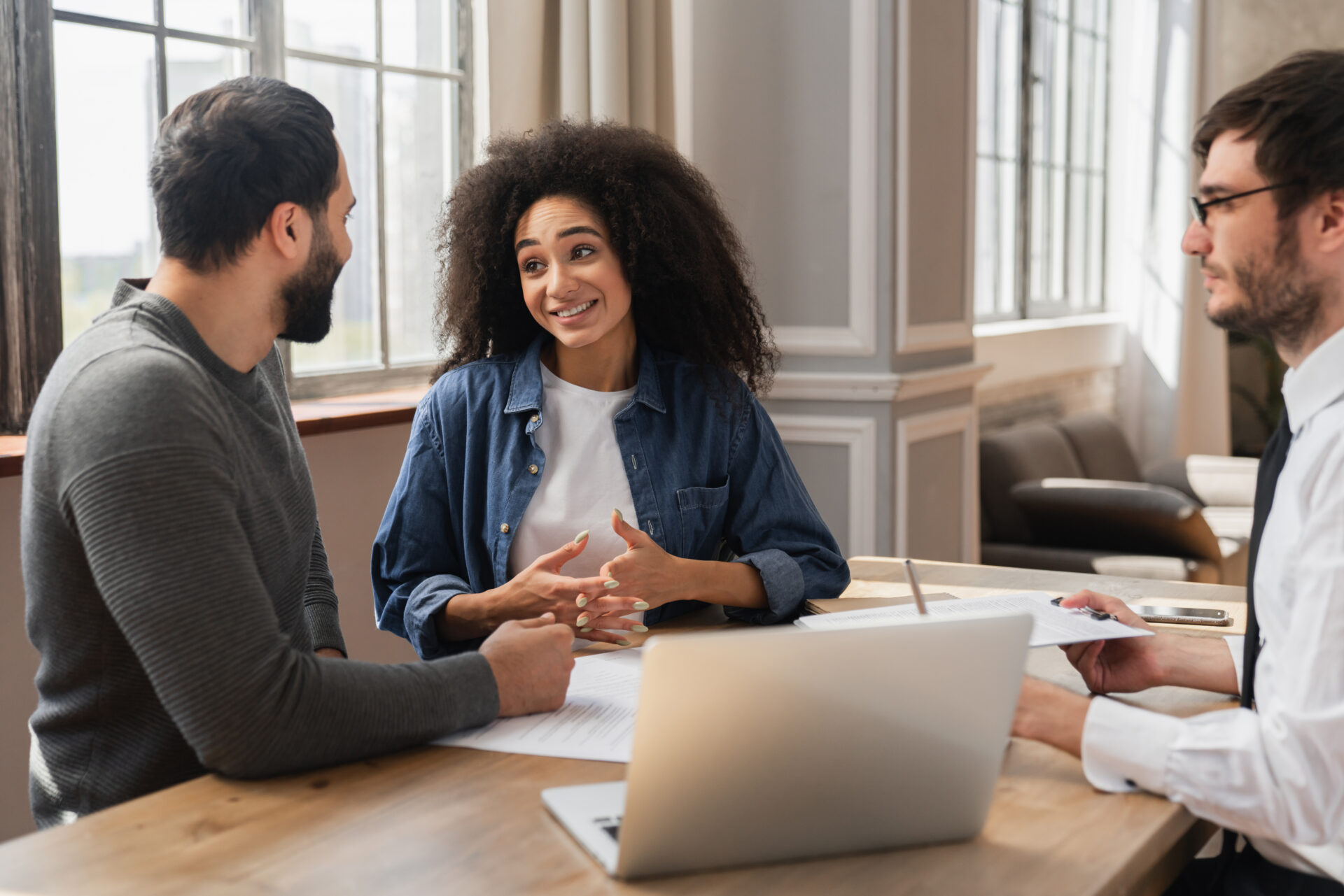 Couple discussing rental paperwork with an agent at a table, reflecting tenant advice and the process of renting a home in Bishopsworth.
