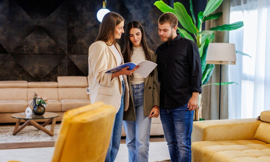 Letting agent reviewing rental property documents with a couple, representing landlord advice and property management in Camberwell.
