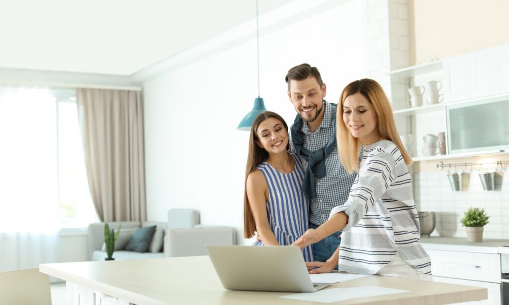 Property professional reviewing rental information with clients inside a modern home, representing landlord advice and lettings support in Harrogate.