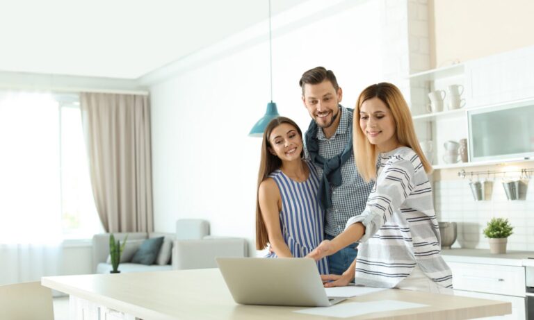 Property professional reviewing rental information with clients inside a modern home, representing landlord advice and lettings support in Harrogate.