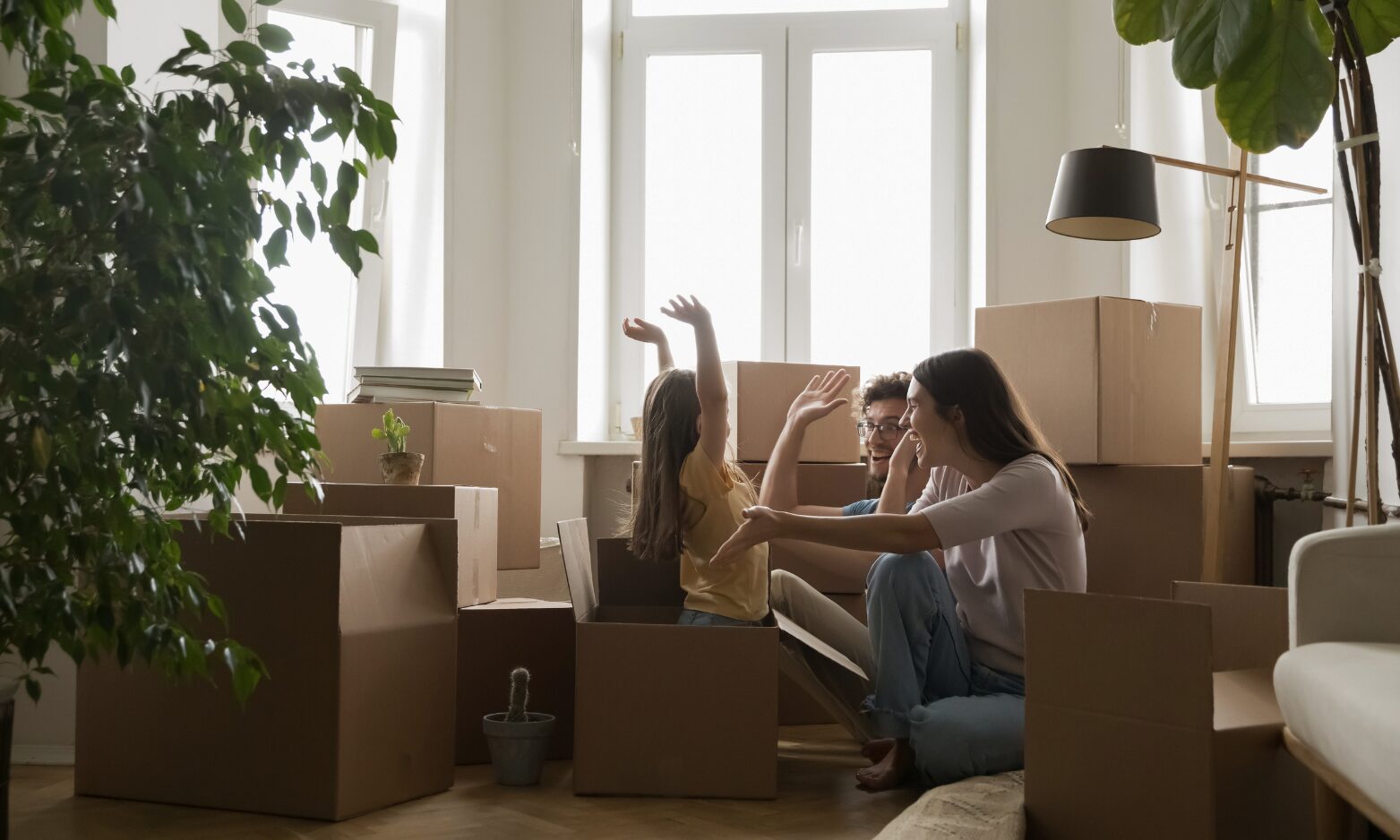 A family unpacking boxes after moving into a rental property in Solihull, highlighting successful property lettings.