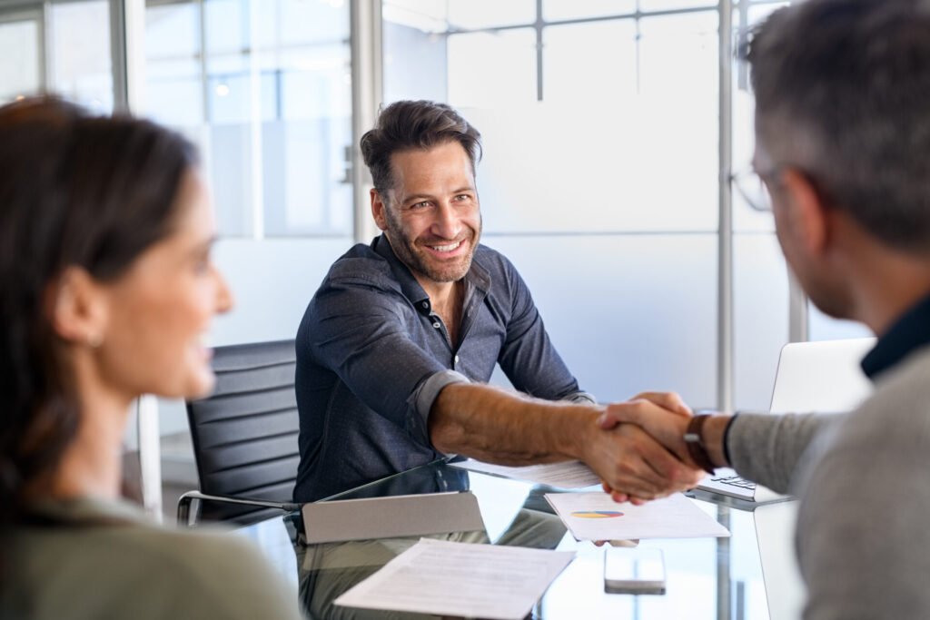 Property investor shaking hands with an adviser during a buy-to-let investment meeting