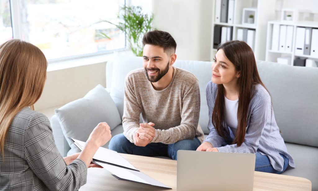 Couple meeting with a property professional to discuss their home and moving options.
