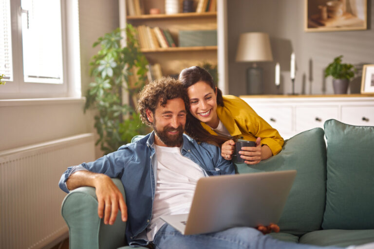 Couple relaxing together on a sofa in a bright modern home, representing the peaceful lifestyle and residential appeal of Hockley Heath B94.