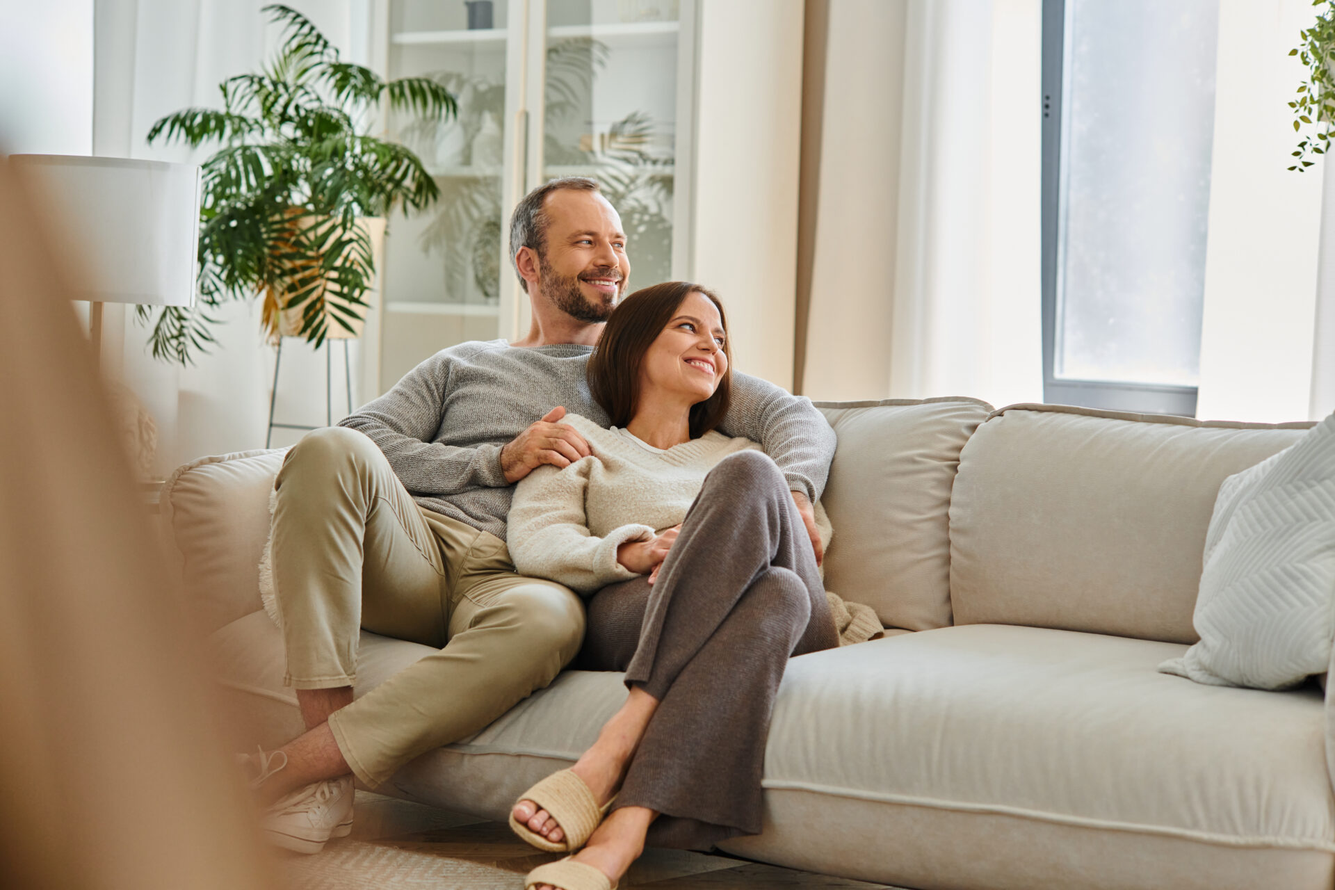 Couple relaxing together in a bright modern living room, representing the welcoming lifestyle and residential appeal of Knaresborough HG5.