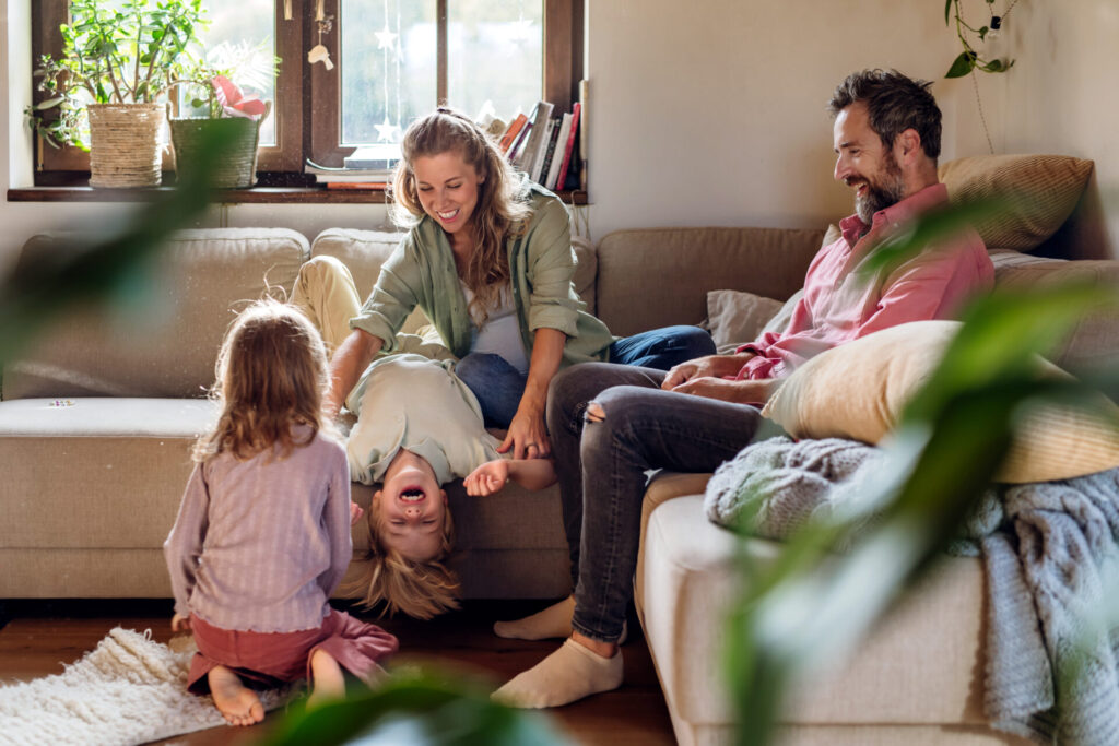 Family spending quality time together in a comfortable living room, representing the welcoming lifestyle and residential appeal of Queensbury HA7.