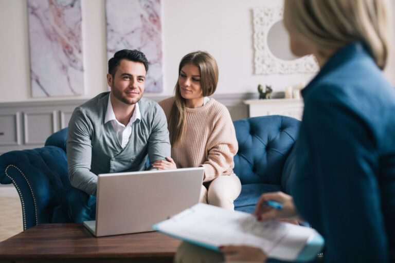 Couple discussing a rental property with a letting agent in Dumfries