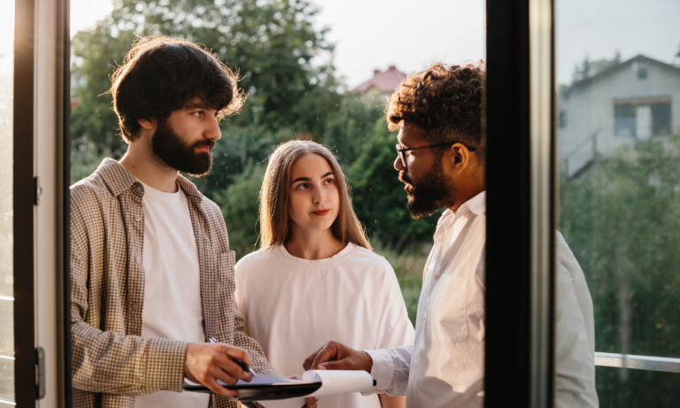Homeowners discussing their property with an estate agent during a home visit in Tamworth.