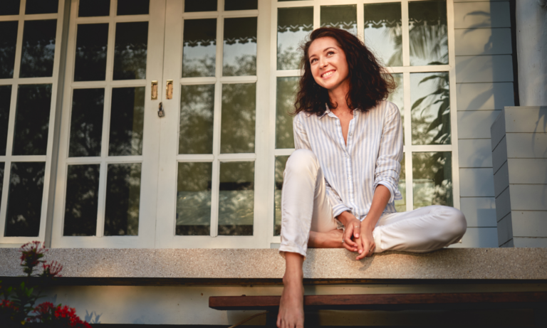 Woman sitting outside her home while considering property prices in Solihull and Birmingham.