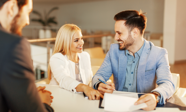 Homeowners discussing their property with an estate agent ahead of selling their home in Solihull.