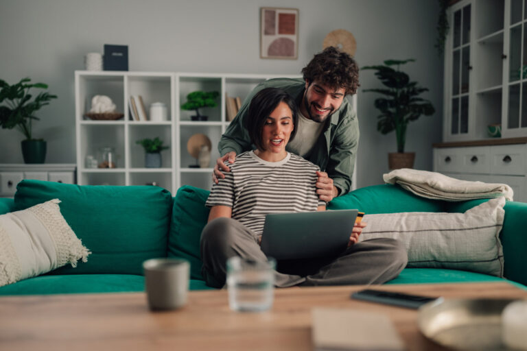 Couple reviewing Stanmore property market information online before selling their home.