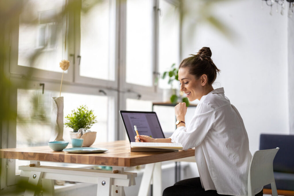 Homebuyer researching the Exeter property market on a laptop before buying a home.