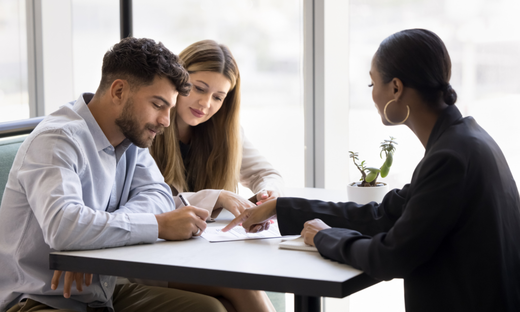 Couple discussing a buy-to-let property investment with a letting agent