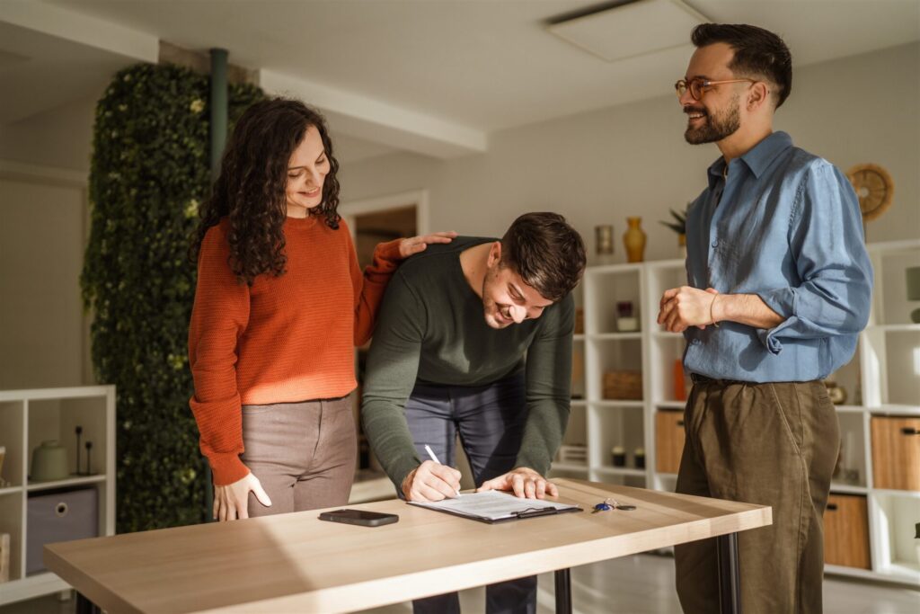 Buyer signing property documents with an estate agent