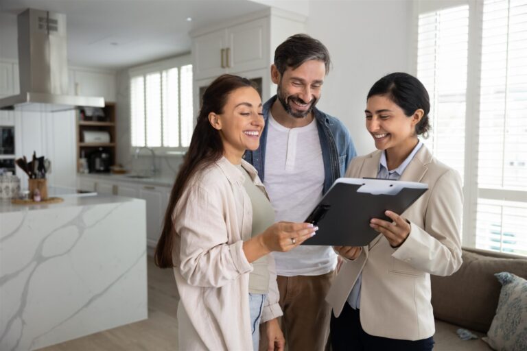 Estate agent discussing property paperwork with a couple