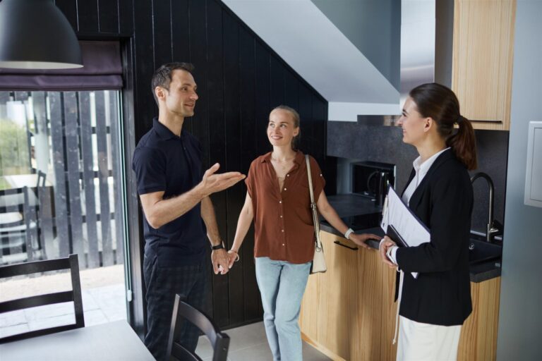 Estate agent showing a couple around a modern home