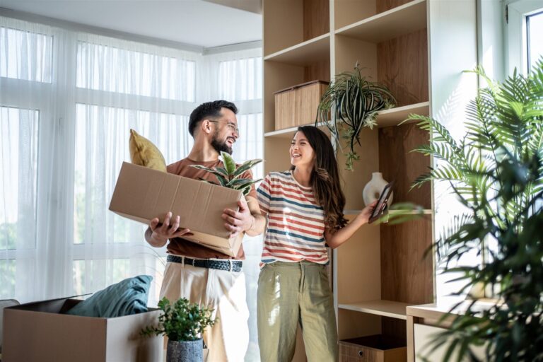Couple unpacking belongings in a bright new home