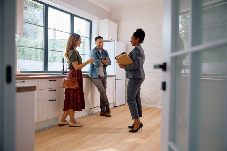 Property agent speaking with prospective tenants in a modern kitchen