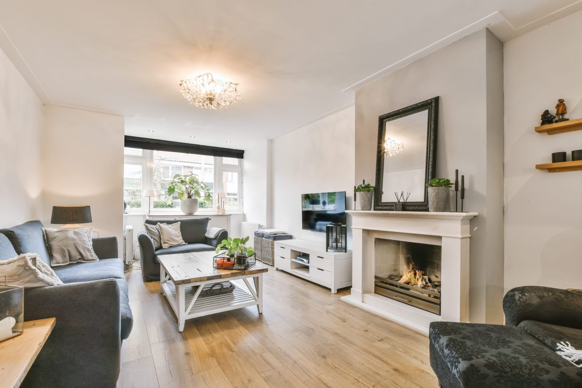 Bright, cosy living room with a lit fireplace in a Kendal home ready for downsizers in LA9