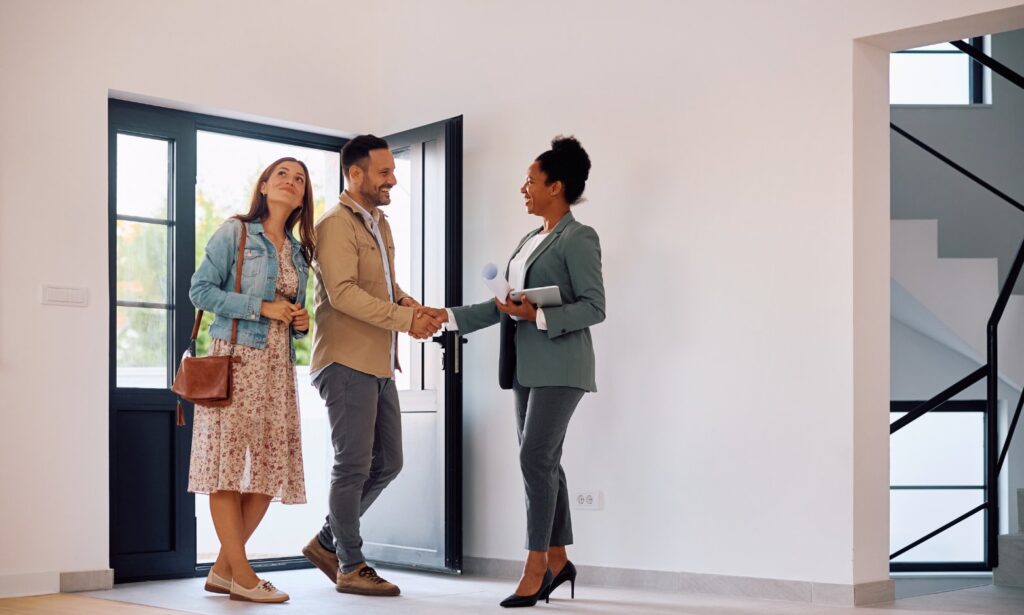 Hunters York letting agent greeting a couple at the front door of a bright rental property