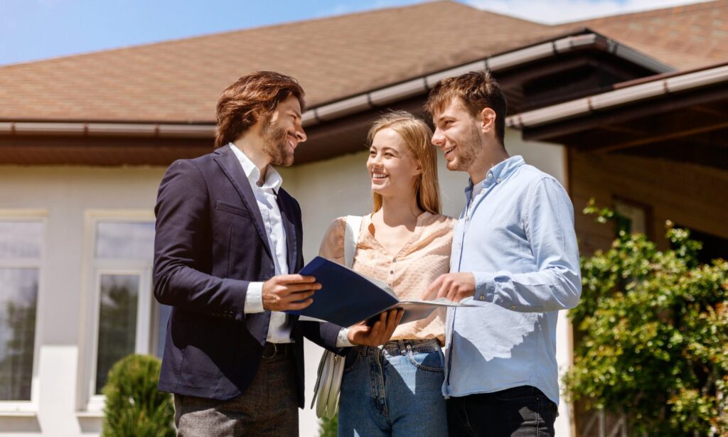 Hunters Sutton Coldfield agent with a folder talking to a couple outside a buy-to-let home